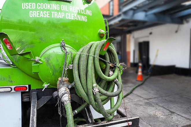 a technician pumping a grease trap in a commercial building in Big River, CA